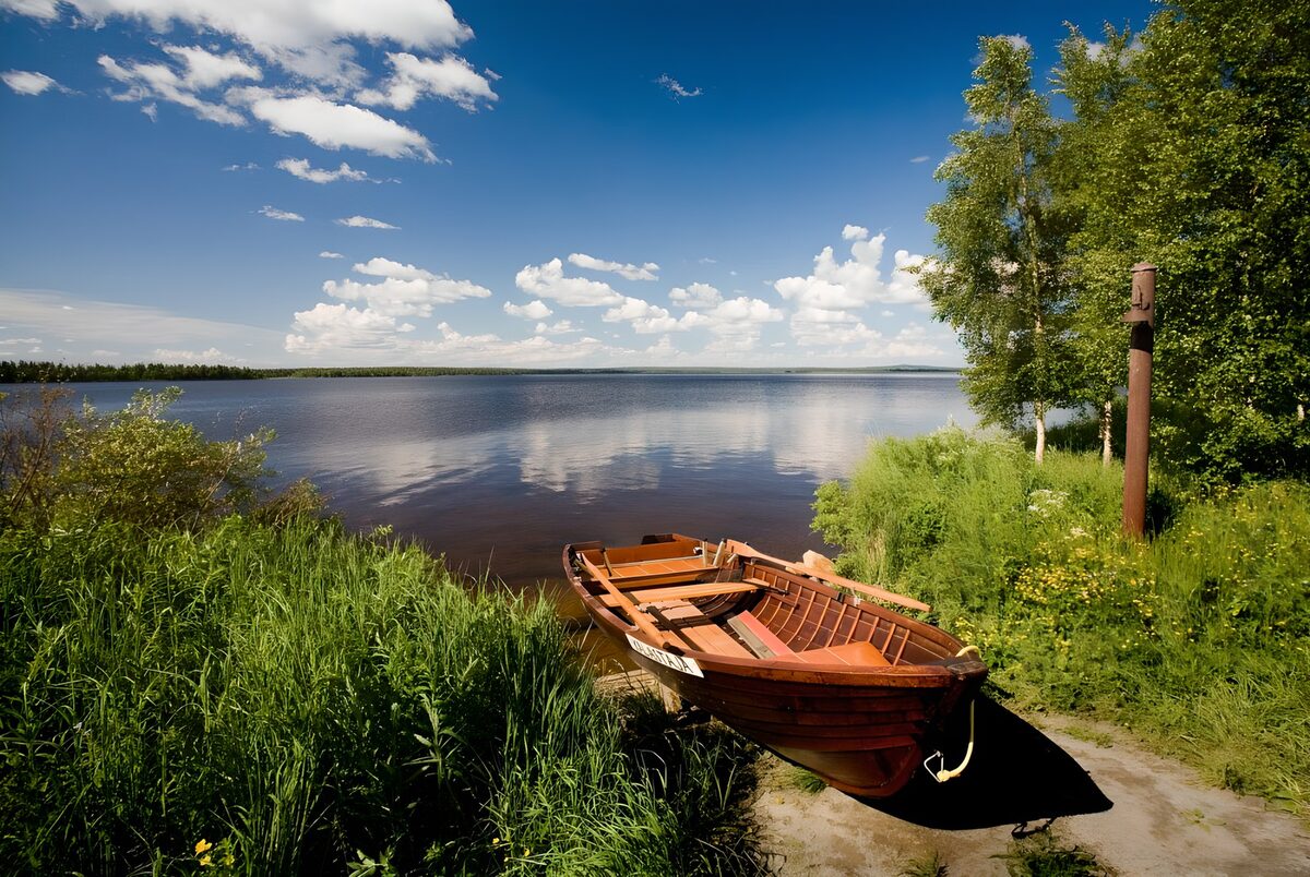 Houten roeiboot aan een zonnig meer