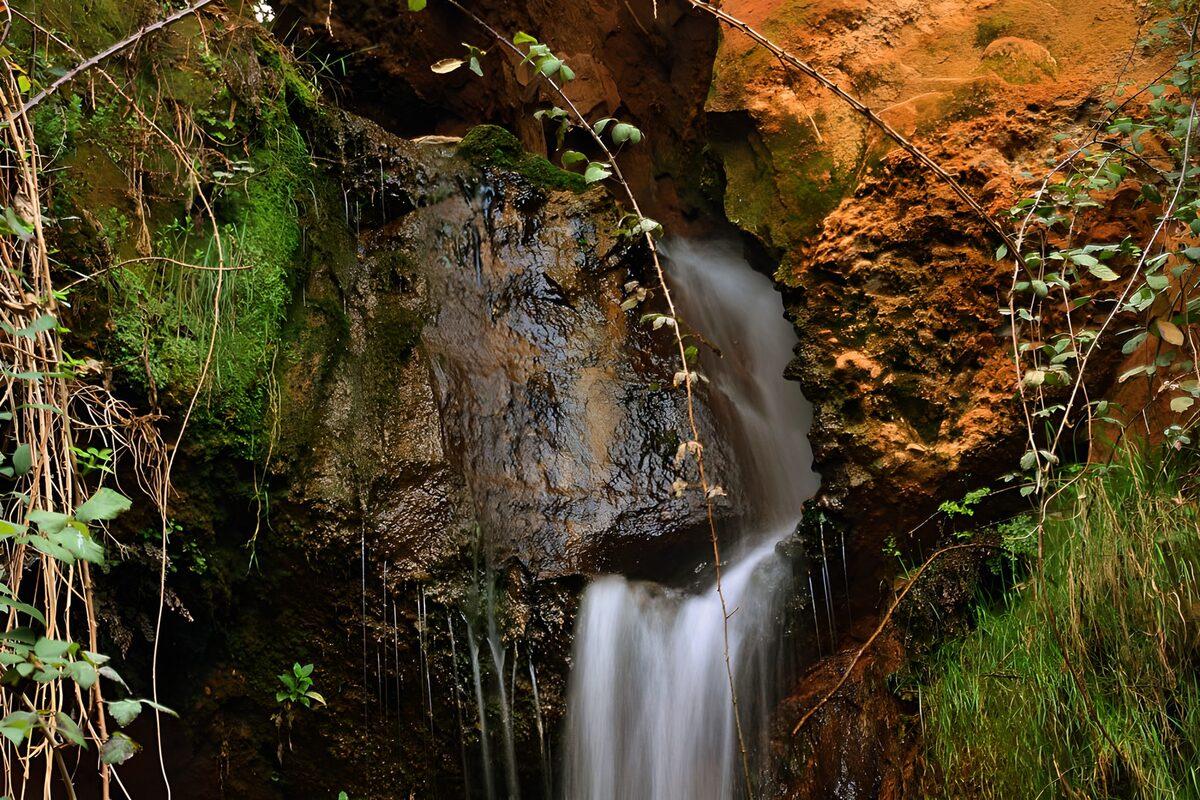 Waterval tussen mos en warme rotsen